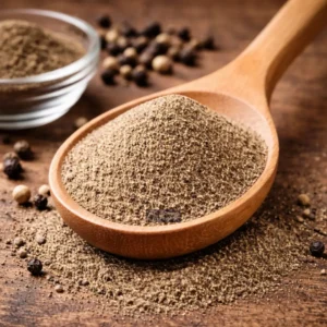 Black Pepper powder on wooden spoon