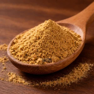 Coriander powder on a wooden spoon