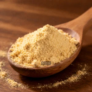 Golden capsicum powder in wooden spoon