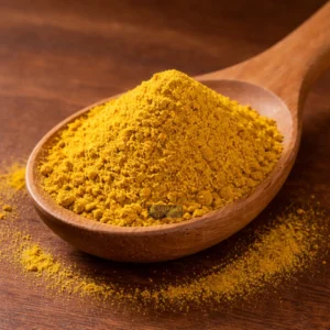 Golden curry powder on wooden spoon