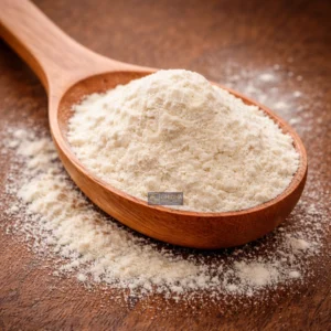 Guar gum powder on wooden spoon