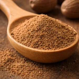 Nutmeg spice in a wooden spoon